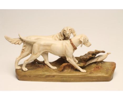 A ROYAL DUX BISQUE PORCELAIN MODEL, 20th century, of two gun dogs flushing out a pheasant on a naturalistically shaped moulde