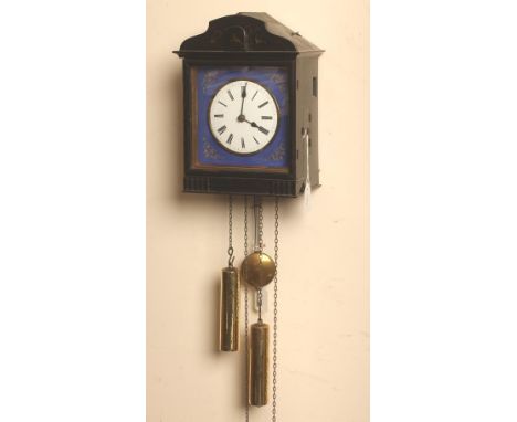 AN EBONISED CASED WALL HANGING CUCKOO CLOCK, the wooden framed two train weight driven movement with anchor escapement striki