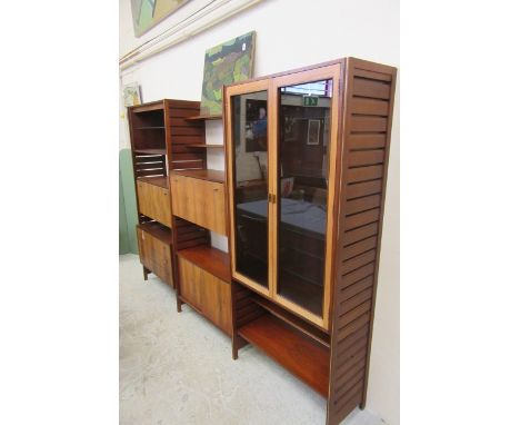 A STAPLES LADDERAX ROSEWOOD STACKING SYSTEM, early 1980's, comprising a tall cabinet with two glazed doors, a three drawer un