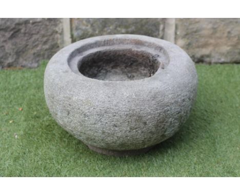 A SMALL GRITSTONE TROUGH of circular tapering form with incurving rim, 17" x 10" (Est. plus 21% premium inc. VAT)