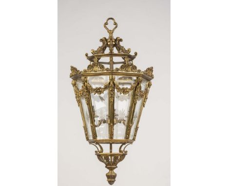 A BRASS PENDANT LANTERN, 20th century, of octagonal tapering form with engraved glass panels, shell and leaf scroll crestings