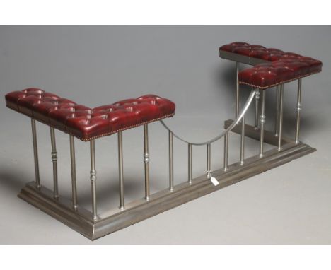 A STEEL CLUB FENDER, 20th century, button upholstered in red leather, knop turned uprights, dished centre and moulded base, 6