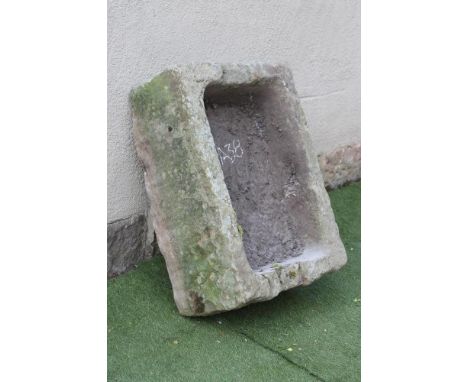 A SANDSTONE TROUGH of rough hewn oblong form, 33" x 21" x 12" (Est. plus 21% premium inc. VAT)