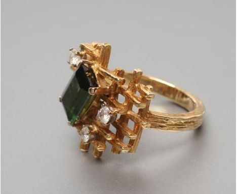 A MODERN 18CT GOLD DRESS RING, the open abstract panel claw set with a Princess cut green tourmaline and three round brillian