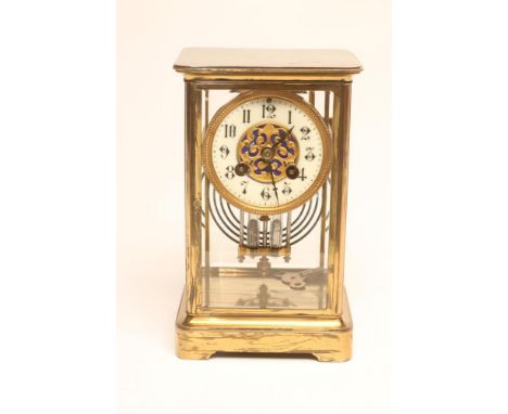 A BRASS CASED FOUR GLASS MANTEL CLOCK, c.1900, the twin barrel movement with Brocot escapement striking on a gong, twin mercu