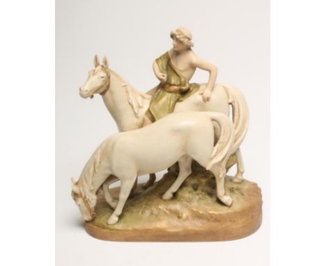 A ROYAL DUX BISQUE PORCELAIN MODEL, early 20th century, as a young male wearing a green toga seated astride a horse with anot