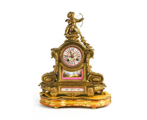 A 19th century French mantle clock, the gilt metal mounts enclosing a porcelain dial and two porcelain panels painted in enam