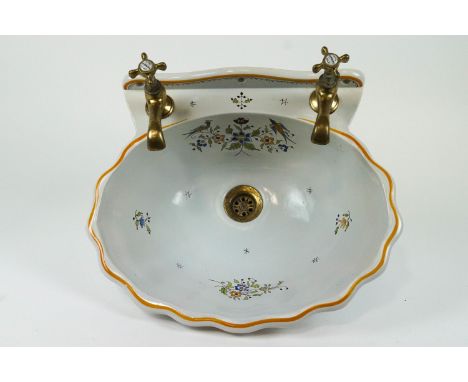 A French femence ( Maurice herbeau,lille) basin of fluted form, painted with blue, green and ochre flower sprays, with brass 