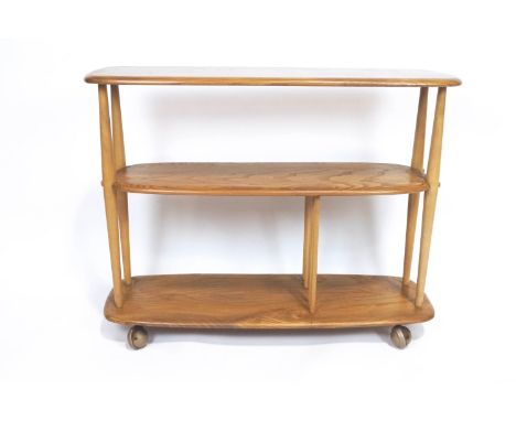 An Ercol light elm three tier shelving unit/bookcase, on castors, 70cm high x 91cm wide x 32cm deep