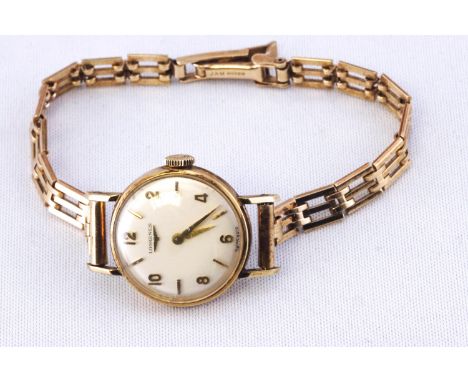 A gold cased Longines wristwatch, mechanical movement, fitted to a gate link bracelet, hallmarked 9ct gold. NB: Case back not