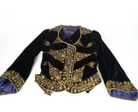 A collection of vintage clothing and textiles to include: an Edwardian brown velvet lady's jacket, a black velvet jacket with