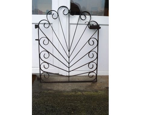 A wrought iron gate in a contrived sunburst design, 105cm high x 88cm wide