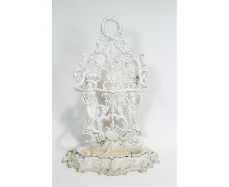 A Coalbrookdale style cast iron white painted umbrella stand, the pierced back plate cast with two supporting figures among s