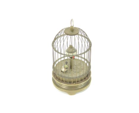 An unusual bird in cage clock, in the form of a 19th century Swiss Automaton, 12cm high