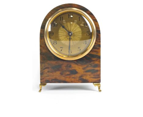 A Continental eight day faux tortoiseshell mantel clock, or arched form, with gilt metal dial, supported on cabriole feet, 17
