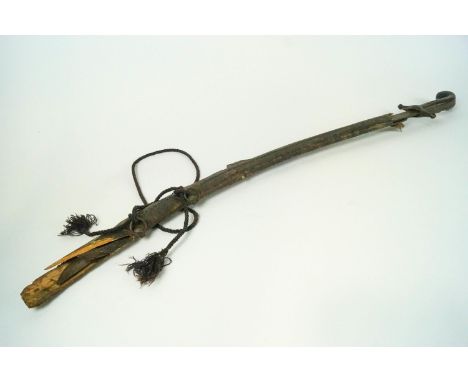 An arab shamshir sword, possibly from Morocco or Algeria, with plain wooden handle and a brass T bar hand guard, with a stamp