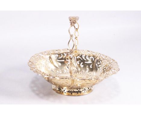 A small silver gilt sweetmeat basket of oval form with pierced panel body with punched flower and shell border and a wirework