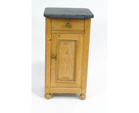 A pine pot cupboard, with slate top above a single drawer and hinged panelled door enclosing a shelf, on bun feet, 78cm high 