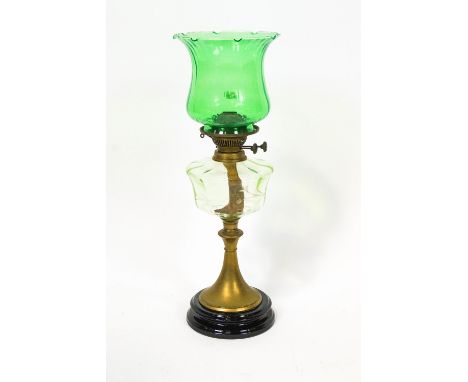 A glass and brass oil lamp,early 20th century with a fluted and flared green glass shade above best British make burner and u