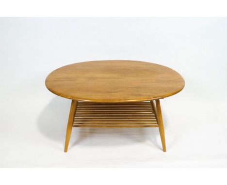 An Ercol elm and beech oval coffee table, with turned spindle lower shelf, 44cm high x 98cm wide x 82.5cm deep