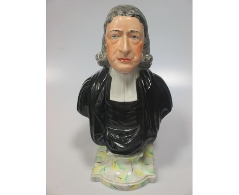 A Staffordshire portrait bust of John Wesley, after a model by Enoch Wood, the reverse moulded with a dedication plaque and r