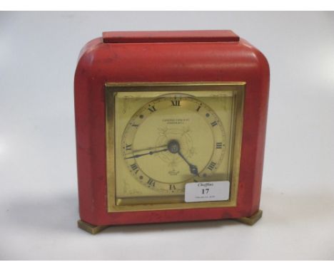 A coral coloured leather covered mantel clock in the Art deco taste retailed by Cameron Cuss and Co  