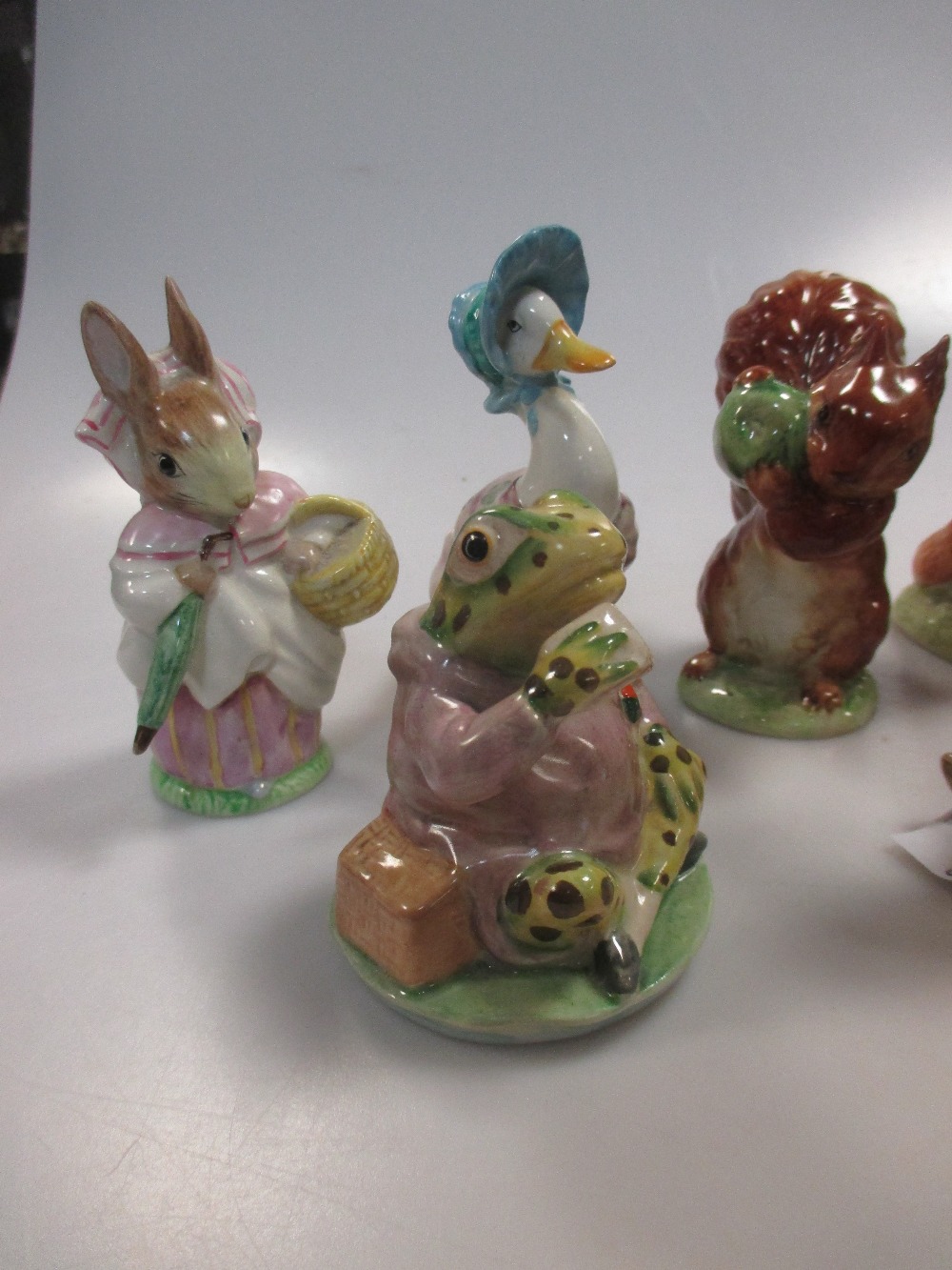 A collection of Beswick Beatrix potter figures, 9 figures with gold ...