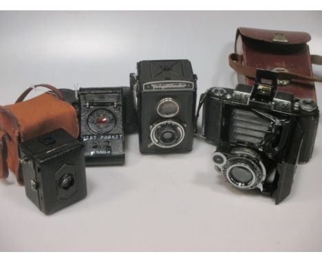 A ZEISS-IKON super-Ikonta 521/2 folding camera - 10.5cm f3.5 lens a Zeiss-Ikon 'Baby Box' camera with canvas case, a Kodak Ea