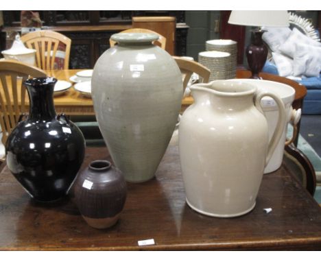 A Studio pottery treacle glaze vase, the shoulder with twin ring handles, 32cm high together with another studio pottery vase