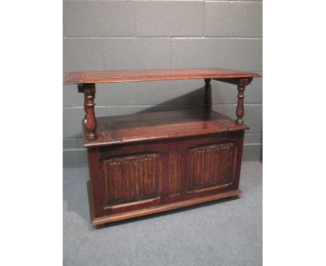 A 19th century oak monks bench with linenfold cupboard doors to base 72 x 92 x 45cm  