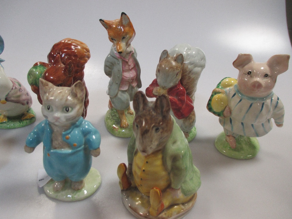 A collection of Beswick Beatrix potter figures, 9 figures with gold ...