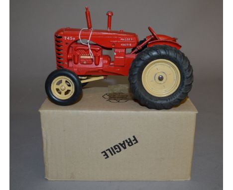 An  unboxed vintage Lesney diecast large scale model of a Massey Harris 745D Tractor in red with lemon hubs and rubber tyres,