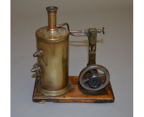 Vertical steam engine with 3" flywheel. Mounted on a 10cm x 20cm wooden base.