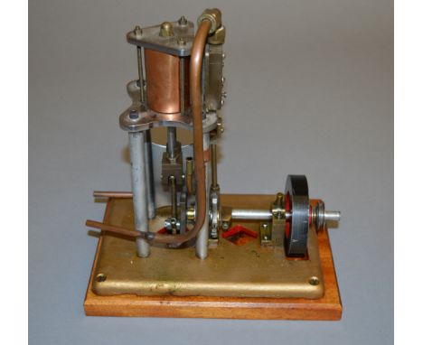 Vertical hot air engine. 3" flywheel. Mounted on a 24cm x 16cm wooden base.