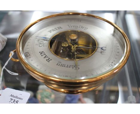 A 19TH CENTURY BRASS ANEROID BAROMETER the silvered dial signed J. Hicks, Haton Garden, London 16.5cm wide