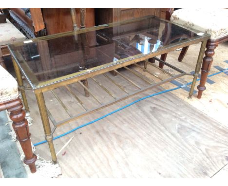 AN EARLY 20TH CENTURY GILT METAL GLASS TOPPED RECTANGULAR COFFEE TABLE with four reeded legs united by a shelf 90cm wide 