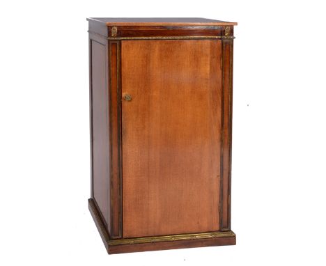 AN EDWARDIAN MAHOGANY AND GILT METAL MOUNTED LIBRARY CABINET, the interior fitted four shelves enclosed by a panel door with 