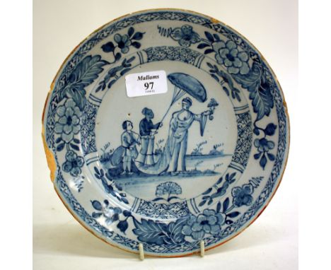 AN ANTIQUE BLUE AND WHITE DELFTWARE PLATE decorated with figures and flowers and having a cross mark to the reverse 22cm diam