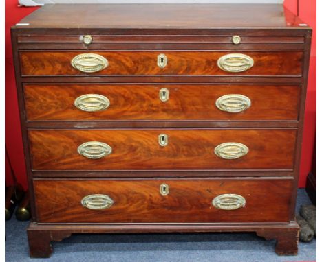 A GEORGE III MAHOGANY CADDY TOP CHEST of four long graduated drawers having a brushing slide, brass handles and bracket feet 