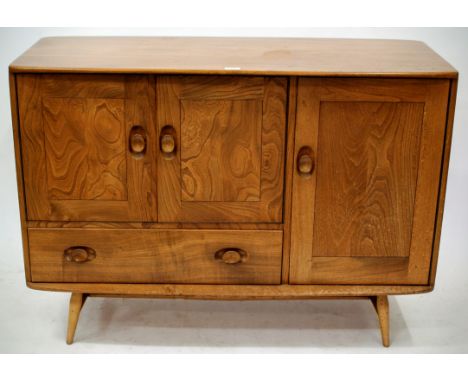 A LIGHT ELM ERCOL SIDEBOARD with three cupboards and one drawer 115cm wide 
