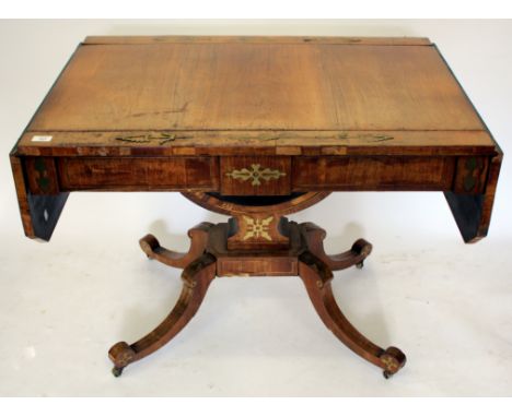 A REGENCY ROSEWOOD AND BRASS INLAID PEDESTAL SOFA TABLE with twin hinged ends, a pair of frieze drawers and four downswept le