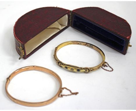 A VICTORIAN 9 CARAT GOLD BANGLE set with two sapphires and a diamond, 6cm wide in a fitted box together with a further 9 cara