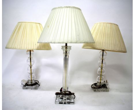 A MODERN GLASS TABLE LAMP of Corinthian column form, approximately 50cm in height together with two further glass lamps (3) R
