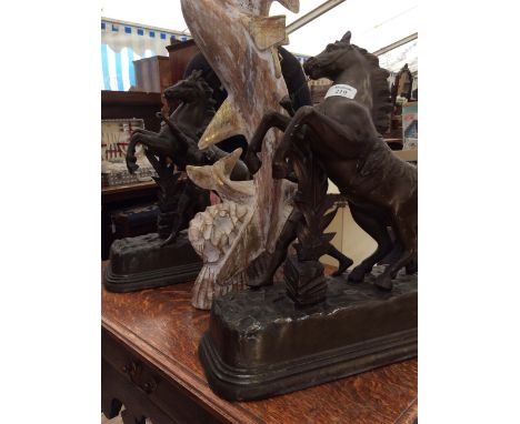 A PAIR OF BRONZED MARLEY REARING HORSE SCULPTURES together with a hanging light fitting and a carved wooden ornament in the f