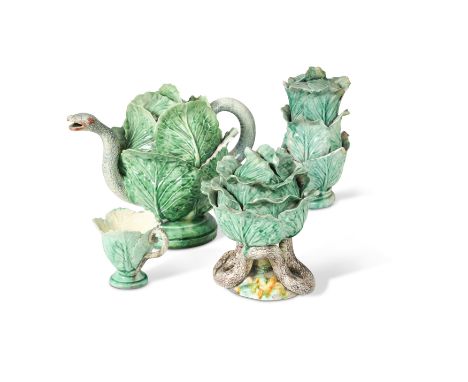 moulded as a cabbage and a snake, comprising teapot and cover, jug and cover, sucrier and cover and a cup the teapot 25cm wid