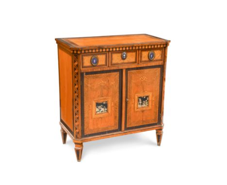 the frieze drawer with gilt metal and enamel applied handles, above a pair of cupboard doors decorated with marquetry frames 