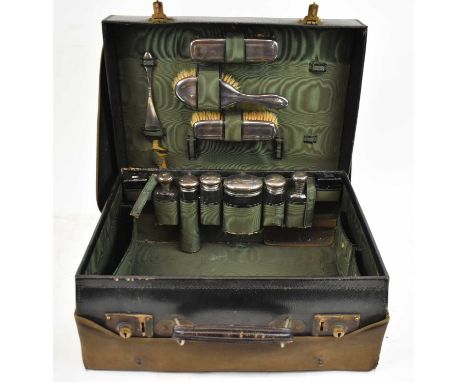 GEORGE HENRY JAMES &amp; CO; a George V leather cased travelling vanity set, enclosing fitted interior, comprising three dres