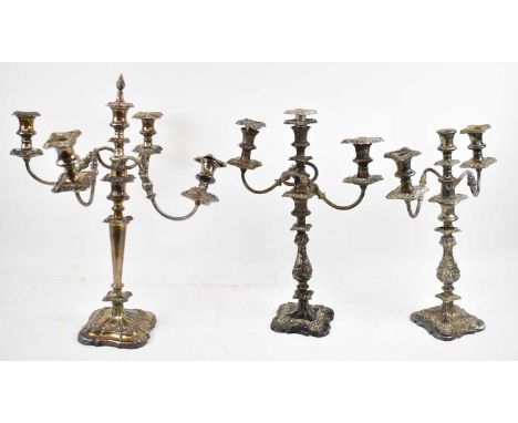 A pair of silver plated three branch candlesticks, height to top 42cm, together with a similar five branch candlestick, heigh