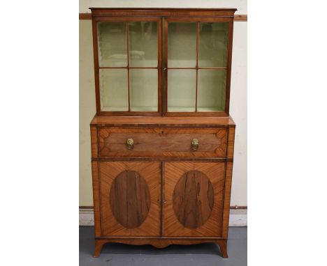 A Regency satinwood rosewood crossbanded and inlaid secretaire bookcase, the two door glazed upper section above the secretai