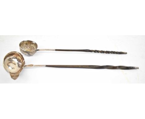 Two white metal wine ladles, both set with coins, length 37cm and 35cm.Condition Report: The handle of the ladle without the 